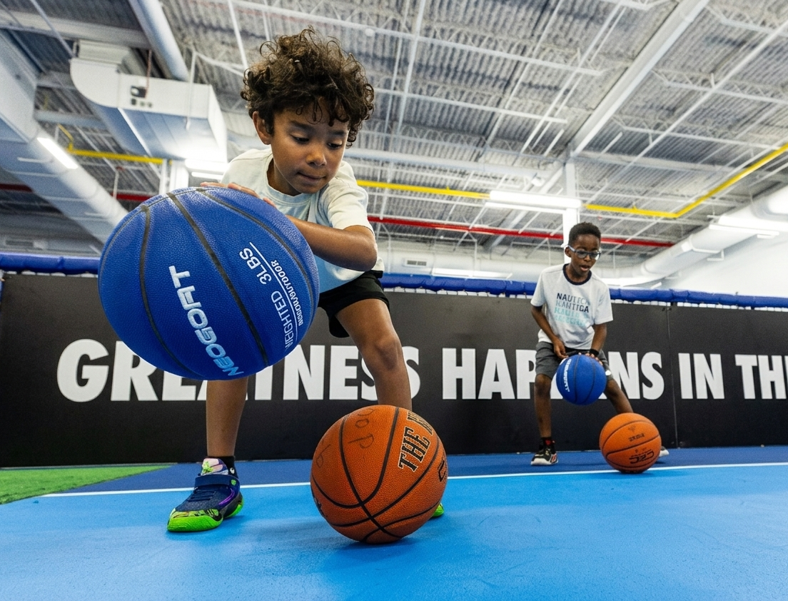 Young player dribbling a weighted basketball at Hoop Lab Wayne